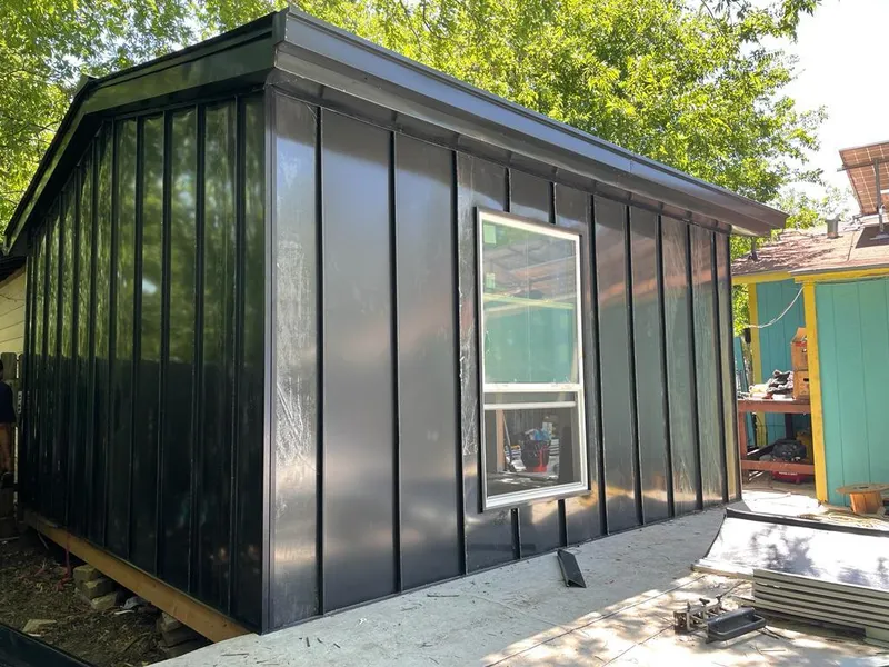 Black standing seam metal wall panels for Roof Inspection in Granger